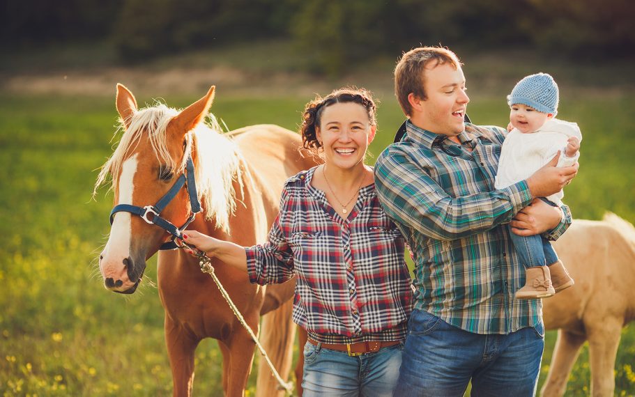 Happy family with a horse